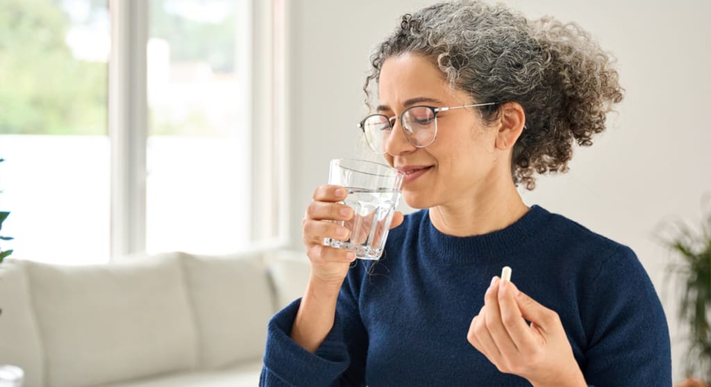 Woman take probiotics supplements